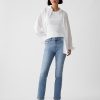 Jeans slim vintage a vita media con orlo diviso Jeans slim vintage a vita media con orlo diviso