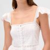 Top corto con peplo in voile con volant in pizzo Top corto con peplo in voile con volant in pizzo